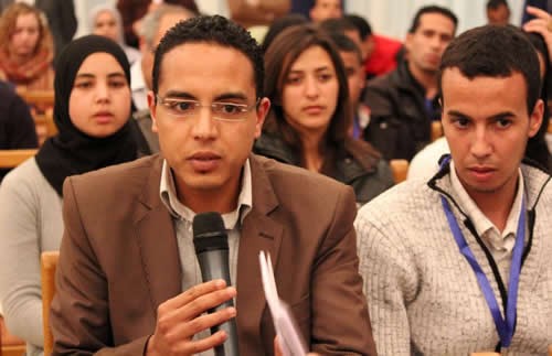 Image of two young Moroccan men speaking at a youth CSO coalition