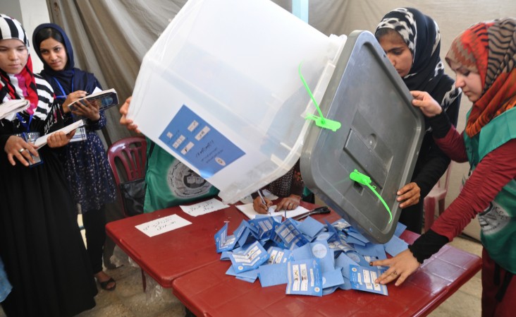 Workers from the Independent Election Commission count ballots.