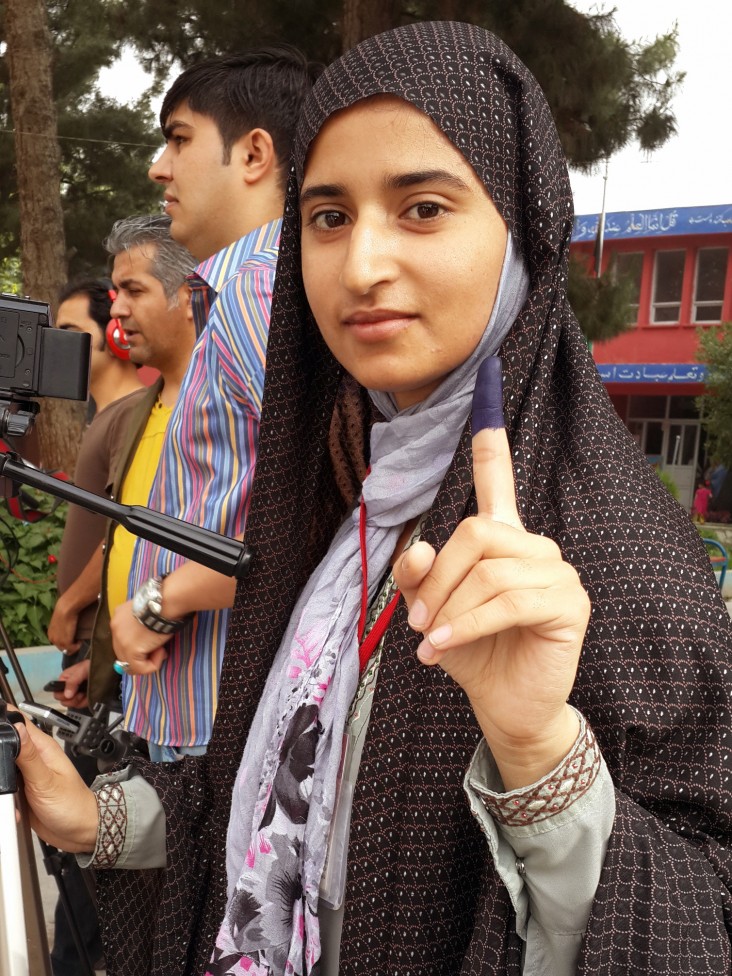 A journalist displays her inked finger after casting her vote in Afghanistan’s western Herat province.