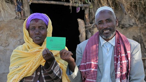 An Ethiopian couple proudly display their jointly issued land certificate, issued under a USAID project in conjunction with the 