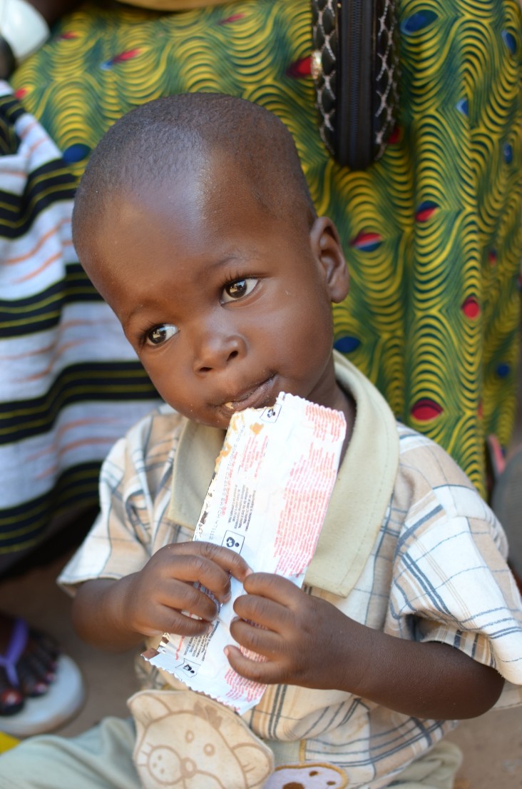 A child in Burkina Faso enjoys a ready-to-use supplementary food product.