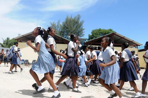 Schoolchildren run to recess at Ecole Marie Dominique Mazzarello in Port-au-Prince on June 18, 2010. The school's classrooms wer