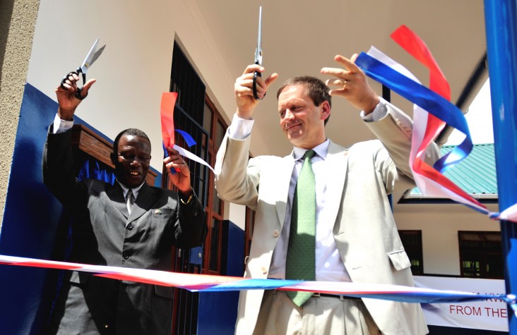 Ambassador Mark Green cuts a ribbon during a dedication ceremony at Jitegemee Secondary School in Dar es Salam, Tanzania.
