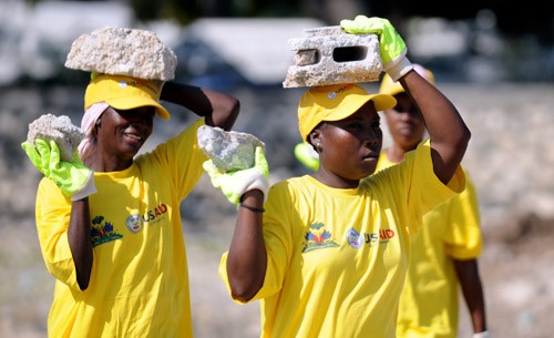Two women carry rubble to be crushed and recycled for use in earthquake recovery efforts in Carrefour, Haiti, Feb. 15, 2011.