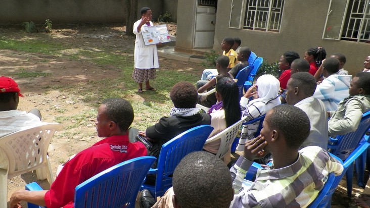 A staff person from the Mbarara clinic runs an education session at the adjacent youth center.