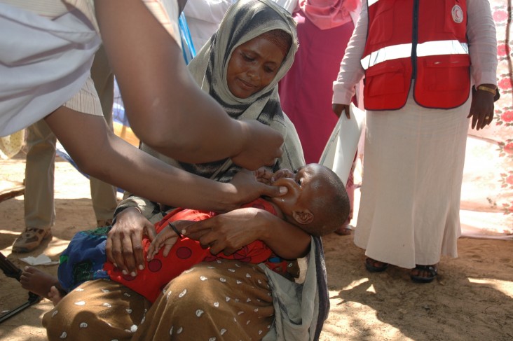 A health worker provides care to a child in Somalia.