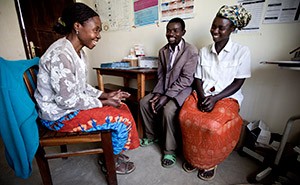 A couple in Uganda receives peer counseling from a community health care worker who has received HIV services.  