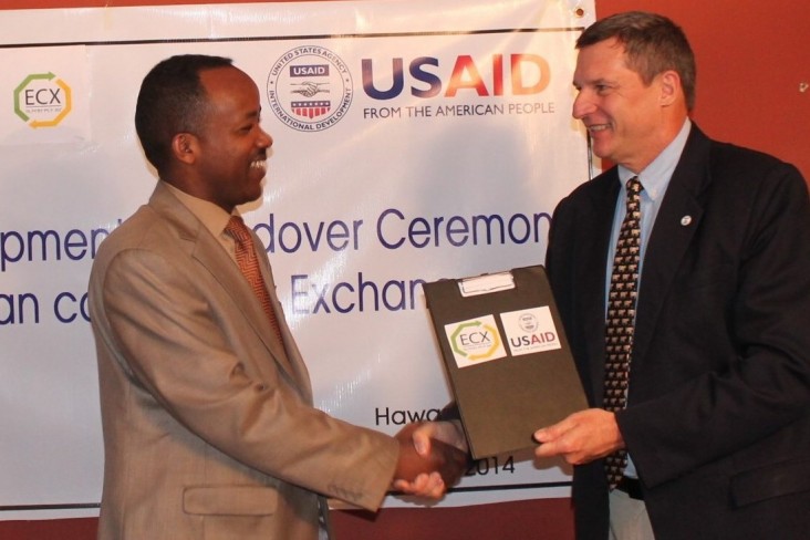 Gary Robbins, a senior official at USAID Ethiopia, presents the ownership documents for the new laboratory instruments.