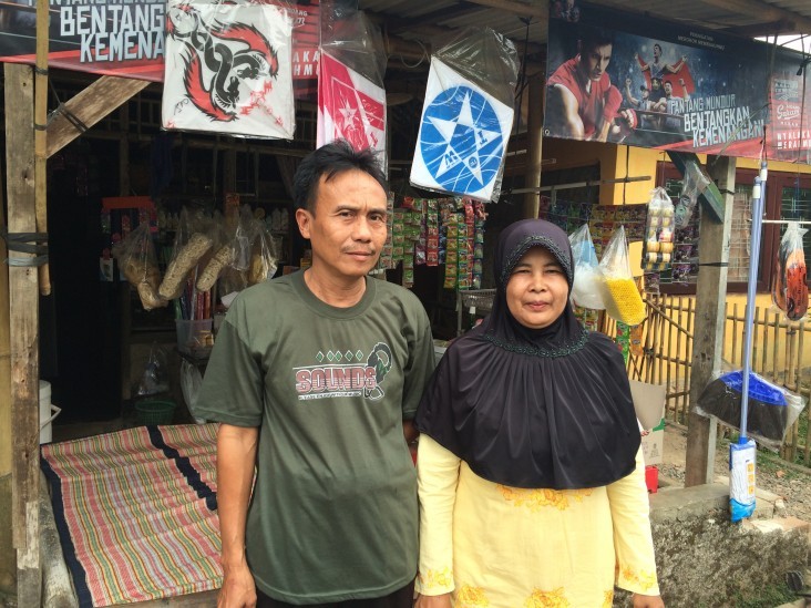 Nurita and her husband stand in front of their business in Indonesia’s Banten province.