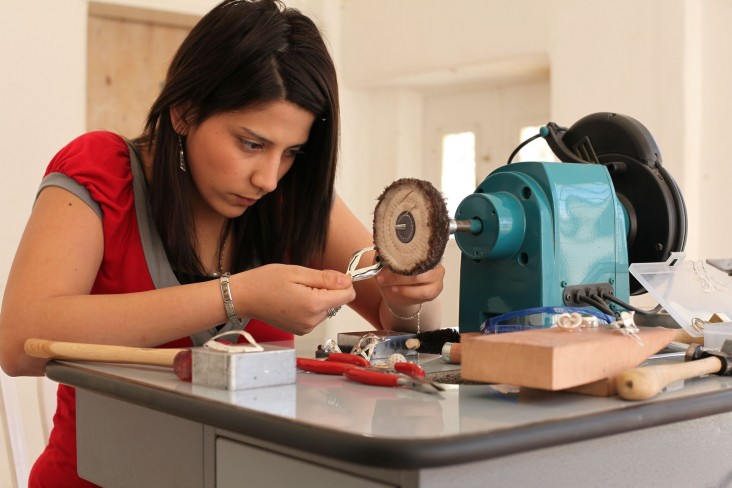 A girl attending a jewelry making course at Dar Al-Kalima College in Bethlehem.