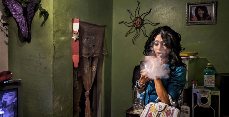 A transgender sex worker in Tijuana, Mexico smokes a cigarette.