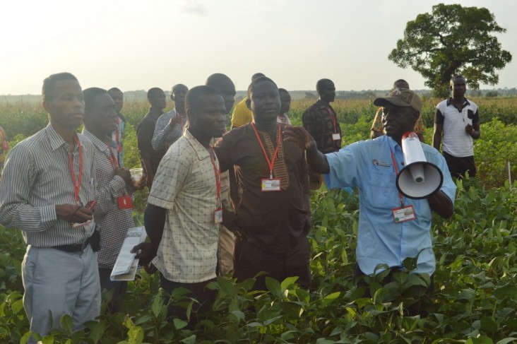 George Awuni, Soybean Innovation Lab SMART Farm manager, right, discusses soybean yields with attendees of the SIL Soybean Kick-off Event in northern Ghana.