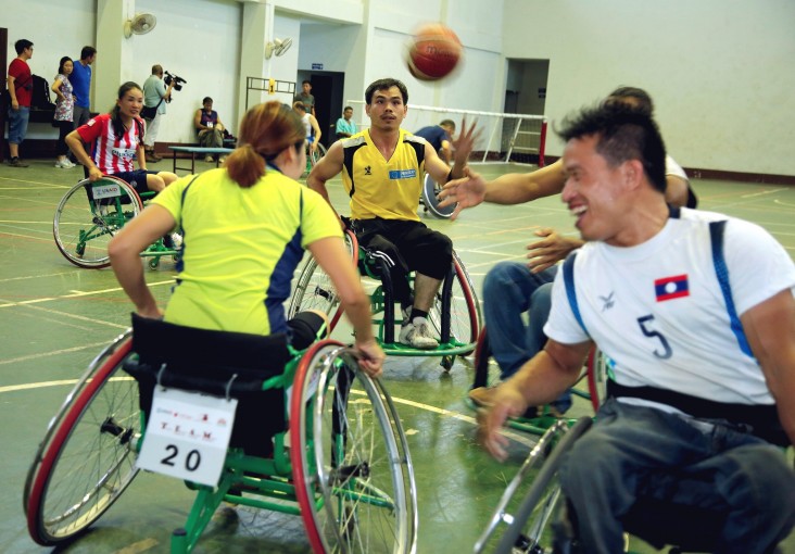 Basketball players in USAID-sponsored wheelchairs enjoy a spirited, friendly game in Vientiane.