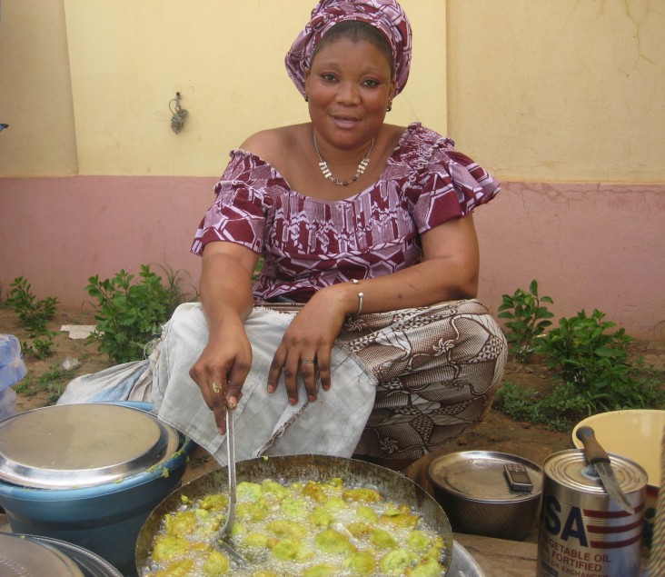 Malian IDP cooking with USAID-procured food