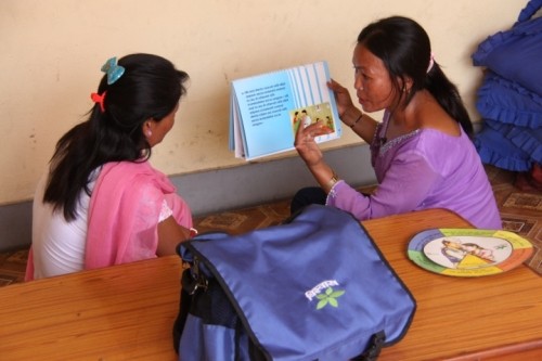 Image of female Nepali outreach worker advising female Nepali sex worker on how to protect herself from HIV and other STIs.