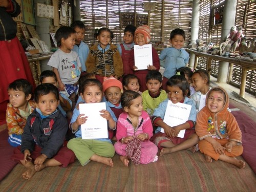 Image of group of about 20 smiling schoolchildren in a USAID-supported Early Childhood Education Development class in Nepal