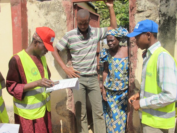 Surveyors interview a household about water usage. Part of reforming the utility involves a customer enumeration exercise that h