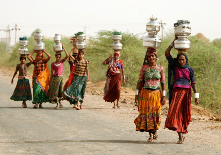 Working Together: Women carry jugs of water in India