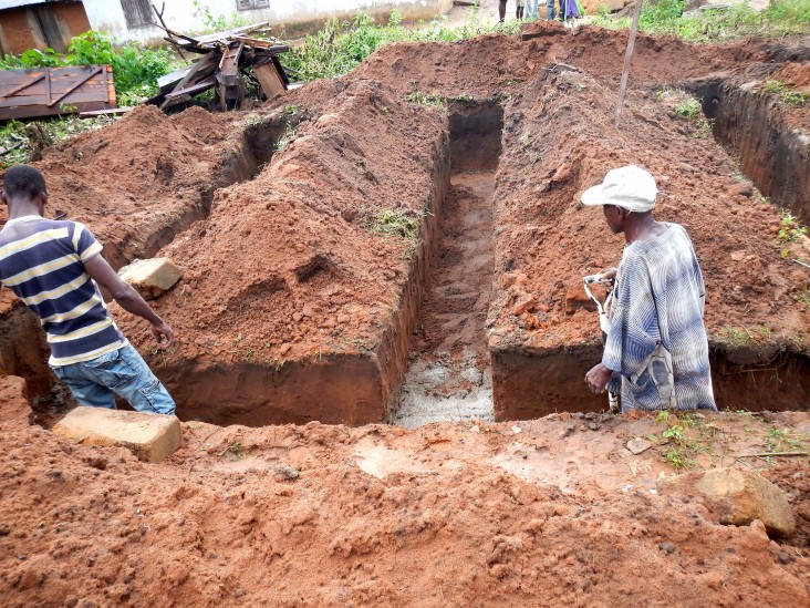 Workers seal the foundation of a powerhouse under construction by GVE Projects and the U.S. African Development Foundation.
