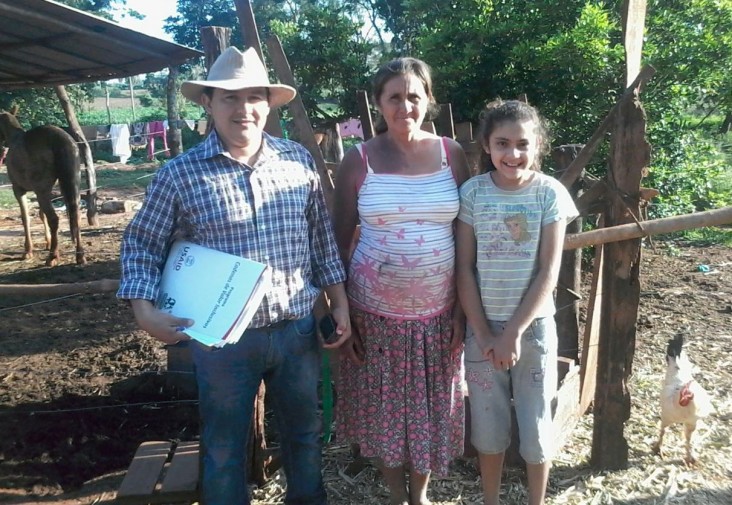 Dairy farmer Bernarda Gonzalez, center, with her daughter and a program specialist after a monitoring visit