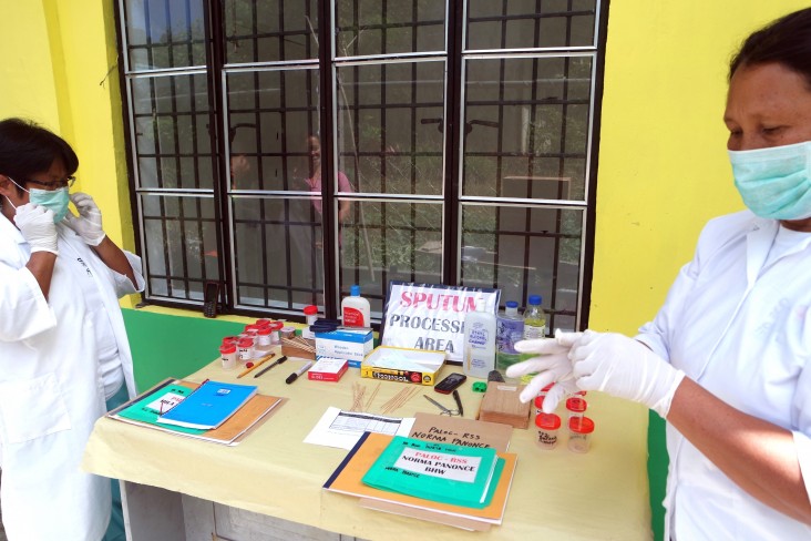 Trained village health workers from the remote village of Paloc, Maragusan, prepare sputum samples.