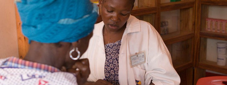 A medical technician talks with a TB patient
