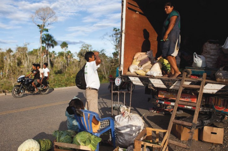 A merchant offers his goods on his truck along the road crossing southeastern Peru near Madre de Dios. Infrastructure improvemen