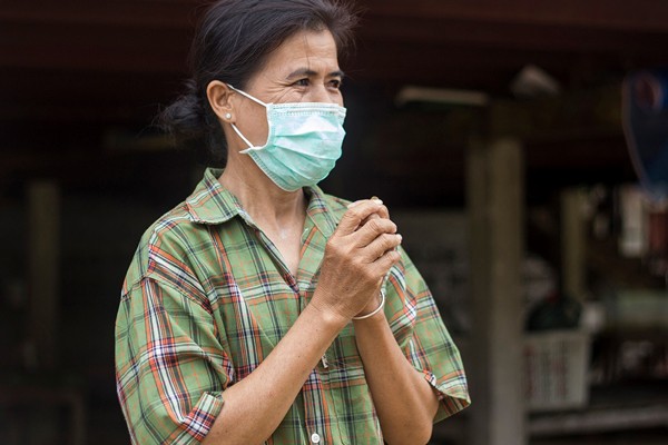A woman wears a mask to prevent the spread of tuberculosis and multi-drug resistant tuberculosis in Rayong, Thailand.
