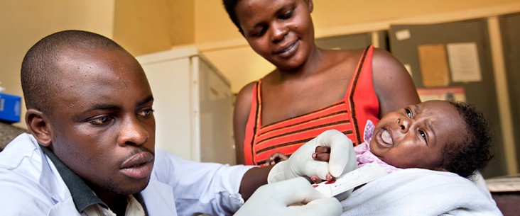 A nurse performs a dry blood spot (DBS) test on Jane’s daughter in a Ugandan clinic