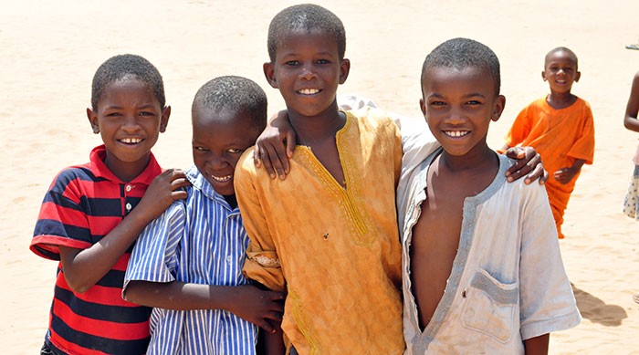 A group of young boys smile at the camera