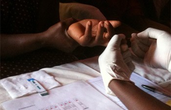 A counselor provides HIV testing and counseling to a family in the home