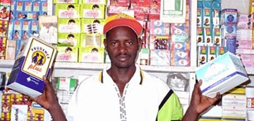 A shopkeeper displaying condoms in Guinea. 