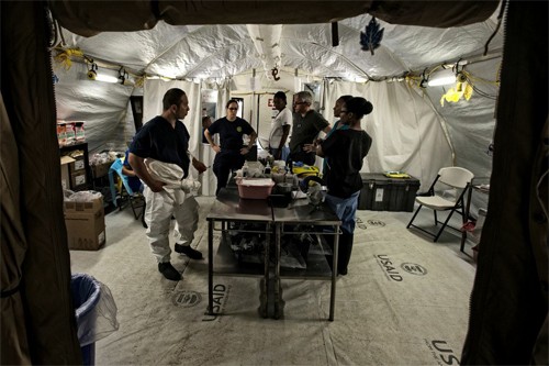 Aid workers prepare for a new possible Ebola case at the MMU