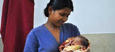 A health worker holds an infant 