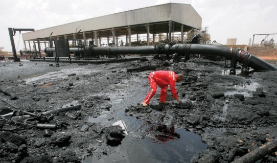 A Sudanese worker inspects damage to a burnt oil-processing facility in Heglig, Sudan. African countries hold vast mineral and e