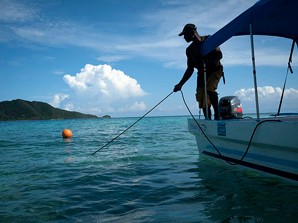 Local fisherman,  Victor Cordova, anchors his boat in the Cayos Cochinos Islands