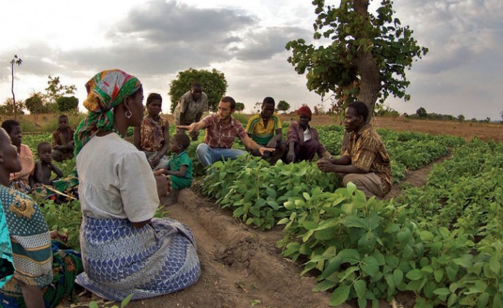 A Peace Corps volunteer trains his local community in Malawi on the nutritional benefits  of growing soy. 