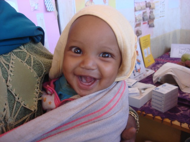 A happy baby at health post for a check-up