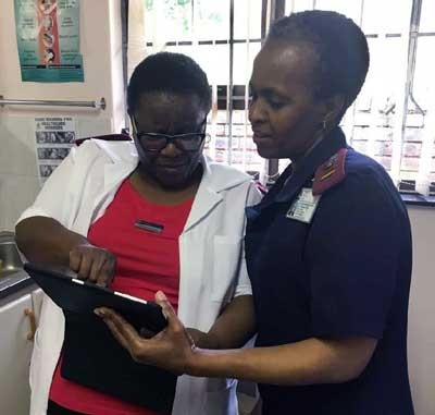Health workers use the Vantage program on a tablet to improve HIV/AIDS service delivery. 