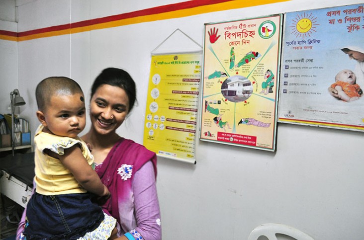 A woman and her baby stand in the Smiling Sun Clinic in Tongi, Bangladesh.