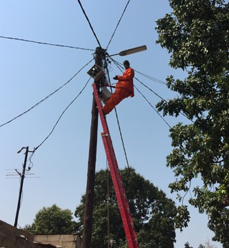 An EdM lineman installs a new meter.