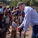 USAID Global Water Coordinator Christian Holmes congratulating children in forest community in Liberia on reaching open defecati