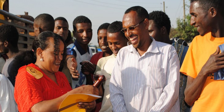 The head of a female sex worker cooperative conducts a street session in Ethiopia on how to use a condom properly.