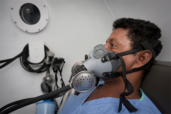 Selin Taylor Wood breathes through a mask in the hyperbaric chamber after suffering an embolism while diving at 86 feet.