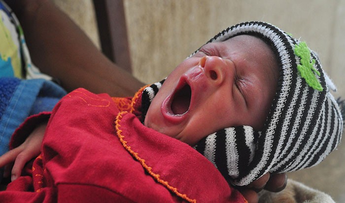 A newborn baby yawns