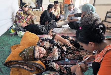 Doctors give a medical care to wounded and sick ethnic Uzbeks at the Kyrgyz-Uzbek border.