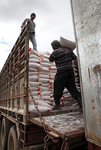 Workers load a truck with flour destined for bakeries in Aleppo Governorate.