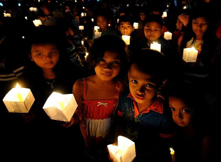Children hold lighted candles during a prayer for Justice and Protection against Sex Trafficking of Children and Young People. 