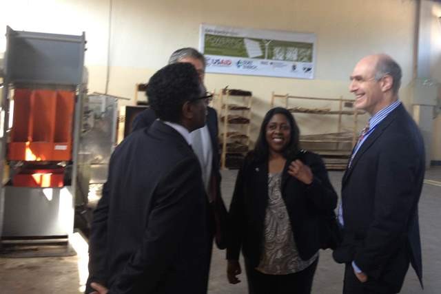 (l-r) African Bamboo’s CEO discusses the Powering Agriculture award with USAID representatives.