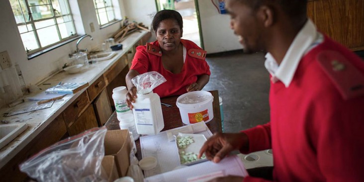 In Uganda, staff help sort antiretroviral medication.